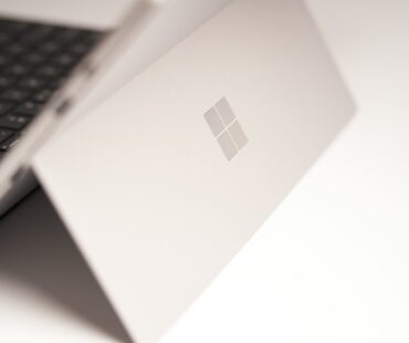 white laptop computer on white table