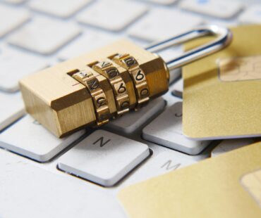 a golden padlock sitting on top of a keyboard