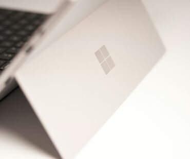 white laptop computer on white table