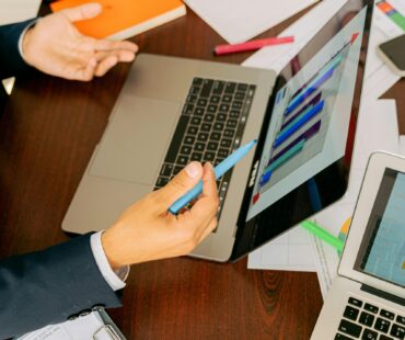 Free A Person in Black Suit Holding a Pen Stock Photo