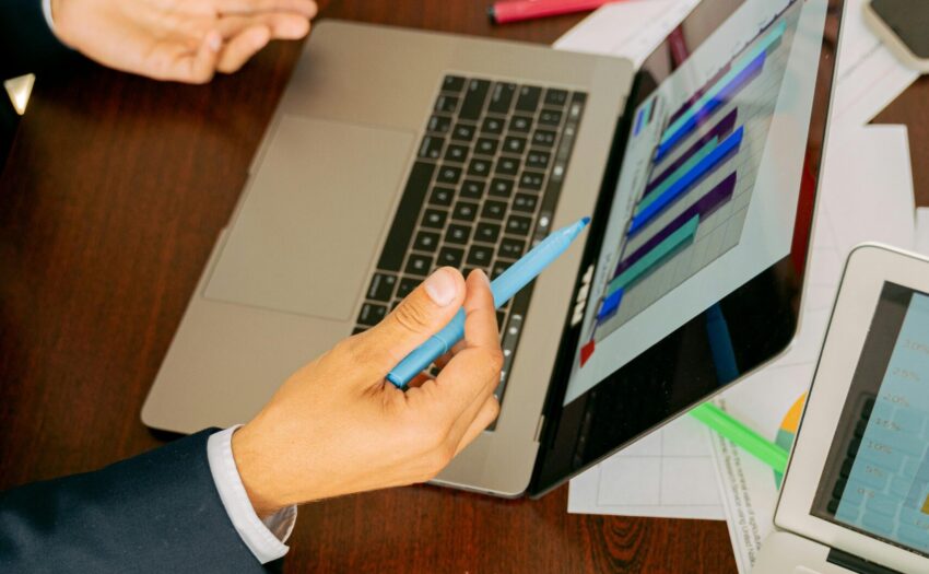 Free A Person in Black Suit Holding a Pen Stock Photo