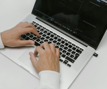 Free Hands on a Laptop Keyboard Stock Photo